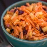 A close up of a bowl of carrot and apple salad