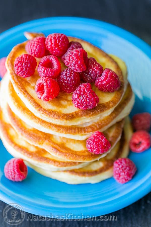 These Greek yogurt pancakes aren't your standard pancakes! They are delicate and crisp on the edges - delicious!| natashaskitchen.com
