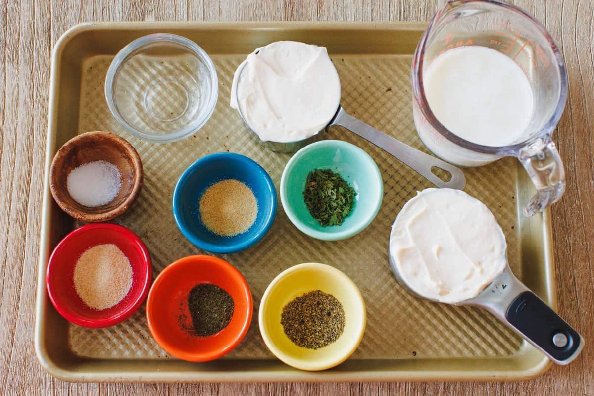 Make restaurant-style buttermilk Ranch Dressing in seconds! This creamy homemade ranch recipe is perfect as a salad dressing or as a dip. The ingredients for homemade buttermilk ranch dressing.