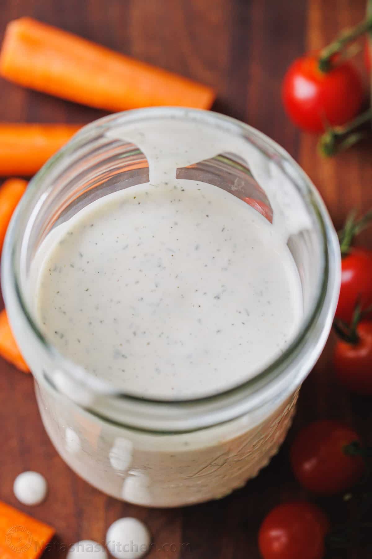 Make restaurant-style buttermilk Ranch Dressing in seconds! This creamy homemade ranch recipe is perfect as a salad dressing or as a dip. Buttermilk ranch dressing in a glass jar.