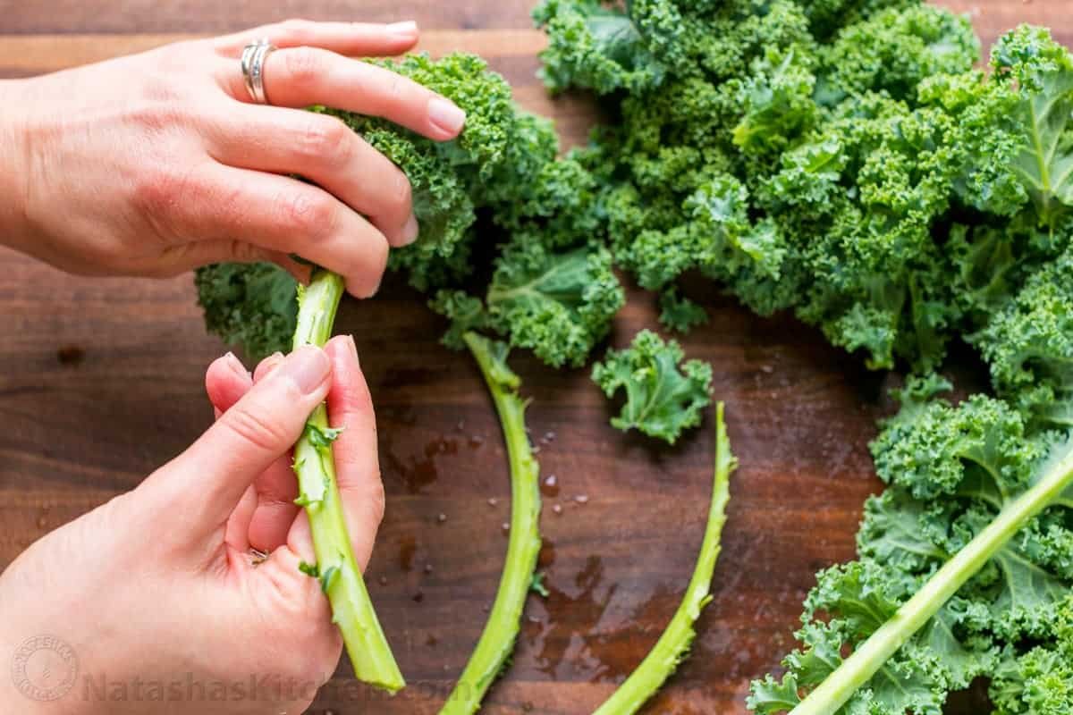 You will love this Autumn-inspired Kale Salad Recipe with apples, pears, cranberries, and toasted pecans with honey lemon dressing. It's so easy to prepare and it's one of the few green salads that can be made ahead. #kalesalad #kalesaladrecipe #kalesaladdressing #salad #saladrecipes How to prepare kale stripping off the leaves