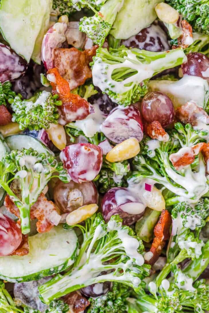 Up close broccoli salad with dressing stirred in