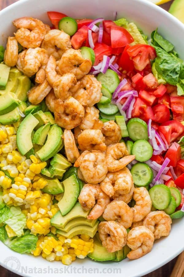 A bowl filled with an avocado shrimp salad 