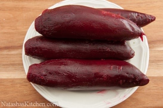 Four large, cooked beets on a plate