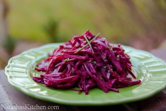 A green plate with julienned creamy beet salad 