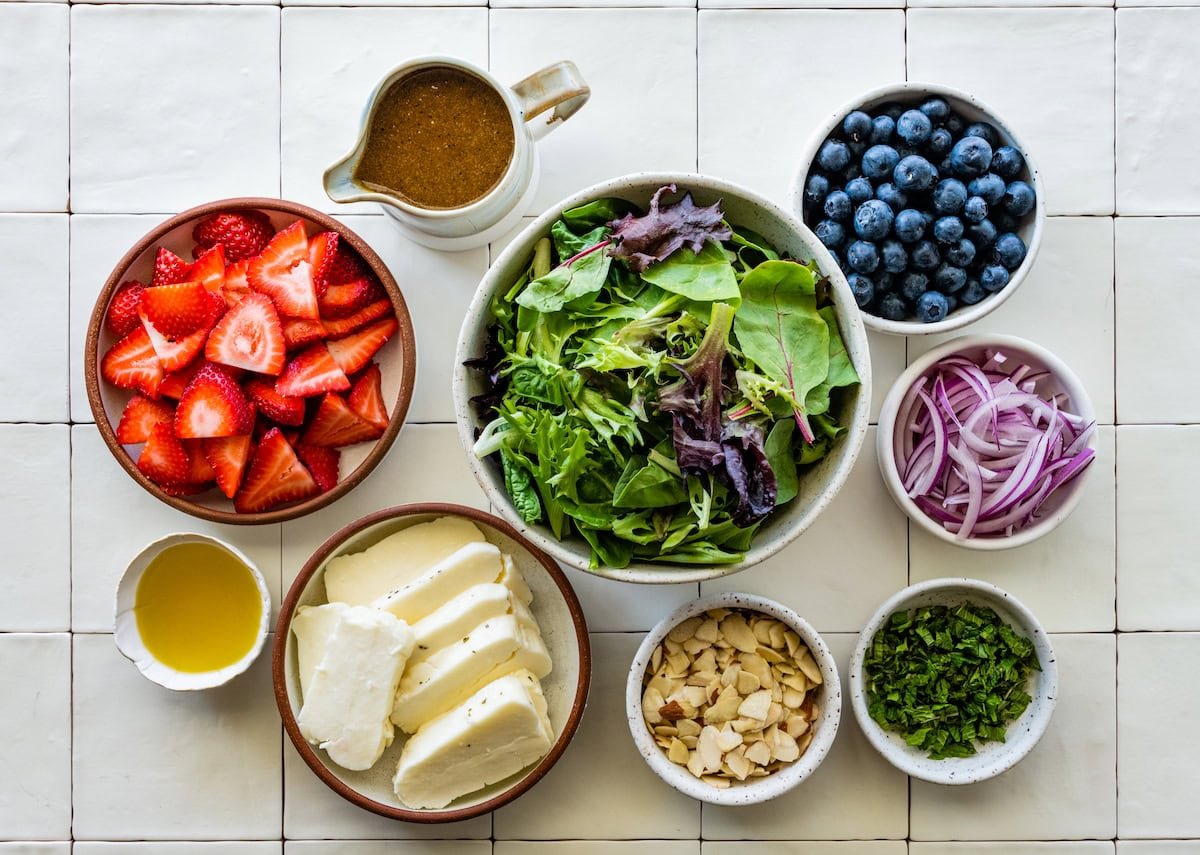 ingredients in bowls to make grilled halloumi berry salad. 