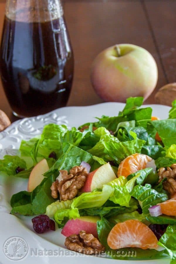 A plate of mandarin apple salad with a whole apple behind it 