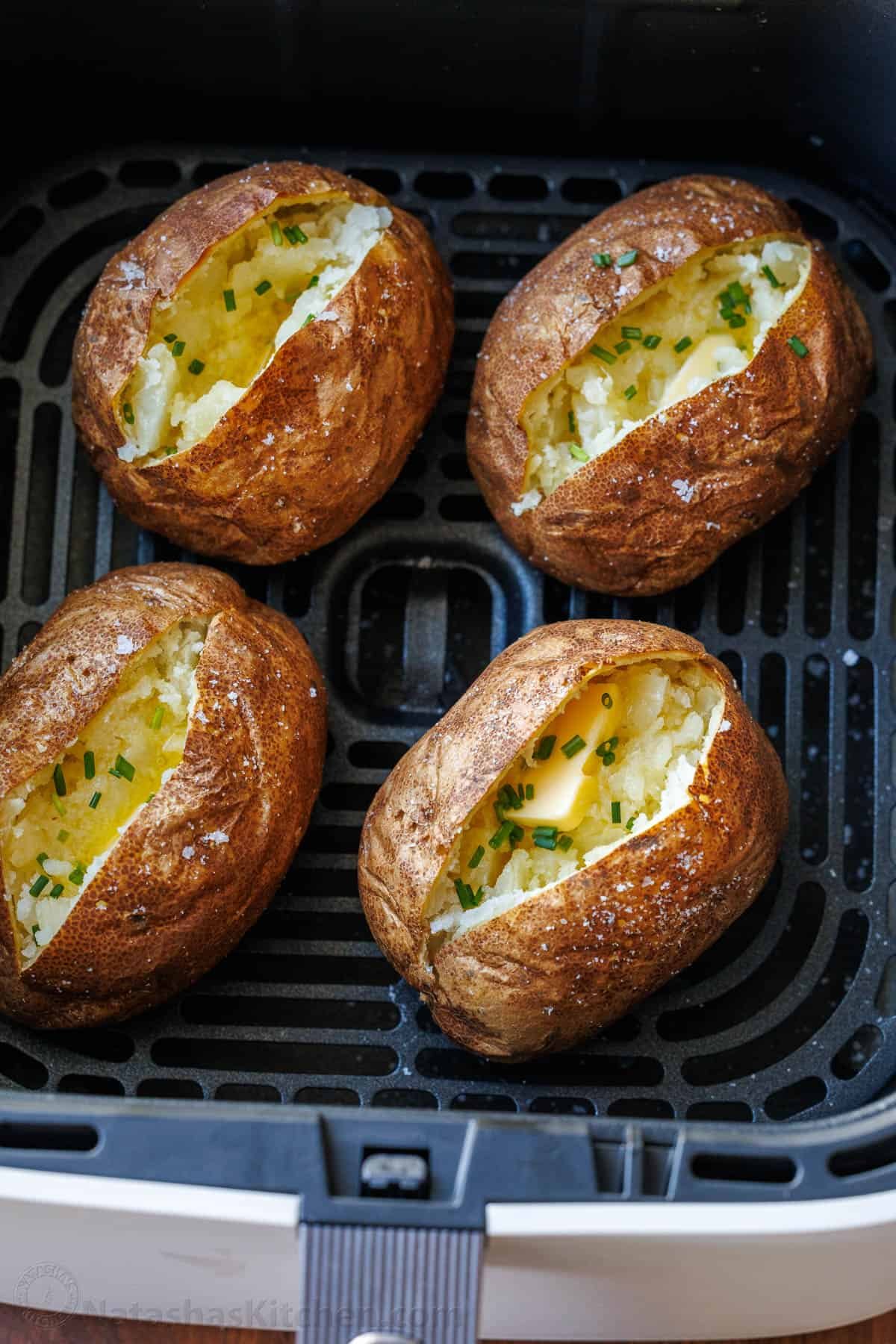 My easy Air Fryer Baked Potato recipe makes the best Baked Potatoes. You'll love the crispy skin with a soft and fluffy center in less time! Air Fryer Baked Potatoes in the air fryer basket
