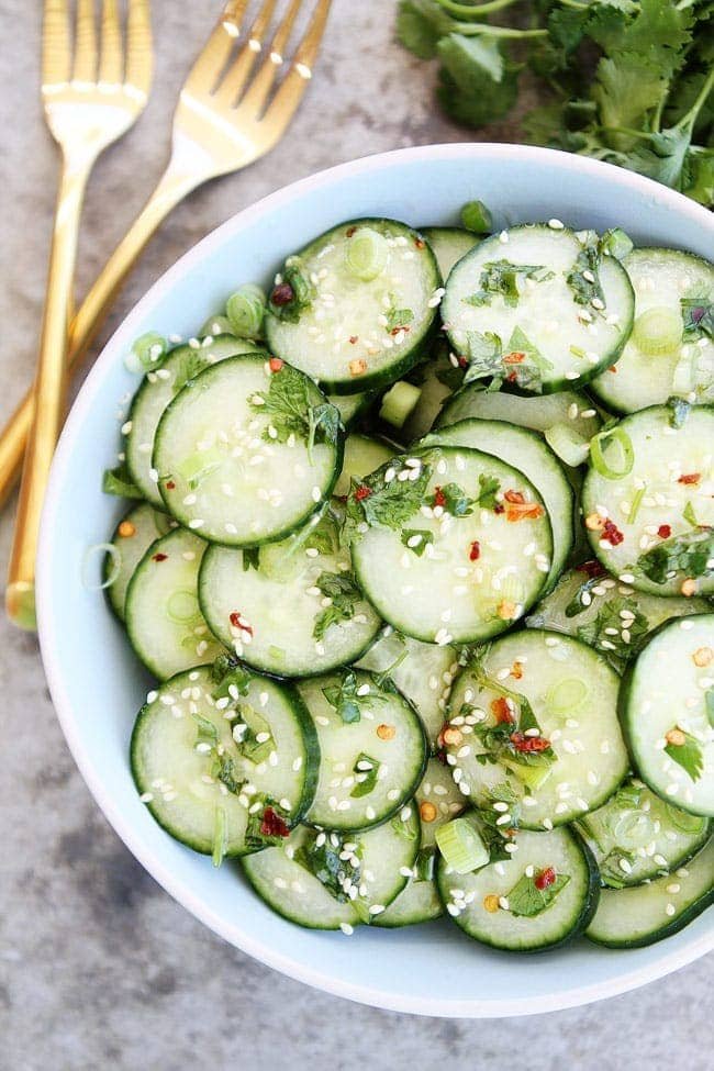 Asian Cucumber Salad is the perfect simple salad for spring and summer. It goes great with any meal. Asian Cucumber Salad with sesame seeds in white serving dish
