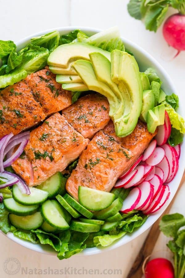 This avocado salmon salad recipe is loaded with all of the best salad ingredients; crisp cucumber and lettuce, and juicy pan seared salmon. The lemon dill dressing is so easy and gives this salmon salad amazing fresh flavor. | natashaskitchen.com