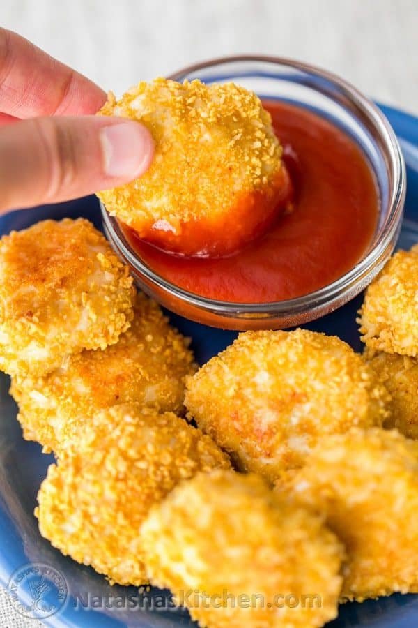 Dipping baked chicken nuggets in ketchup