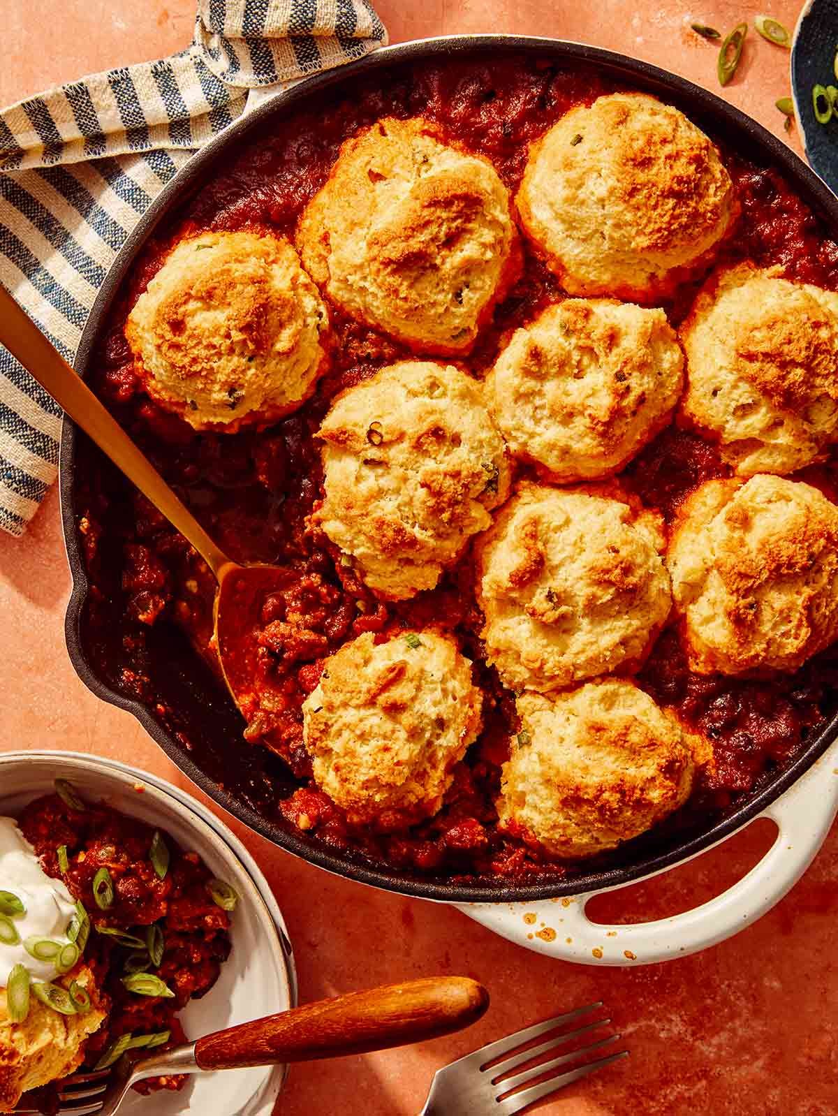 Chili Cornbread Casserole in a skillet with a scoop taken out.