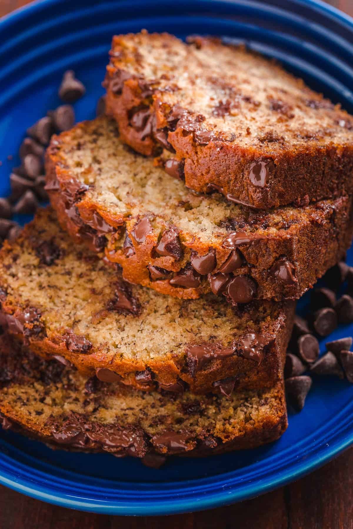 Chocolate Chip banana bread sliced on a plate studded with chocolate chips and bananas