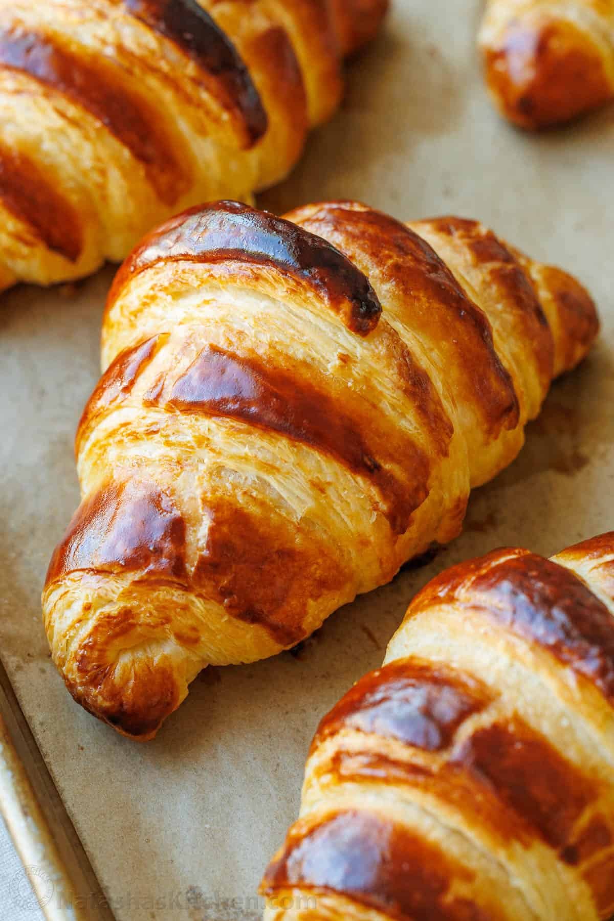 Freshly baked French croissant—crispy on the outside and soft on the inside. With tips from Paris, I've perfected this recipe and know you will love it! Golden baked, flaky croissant