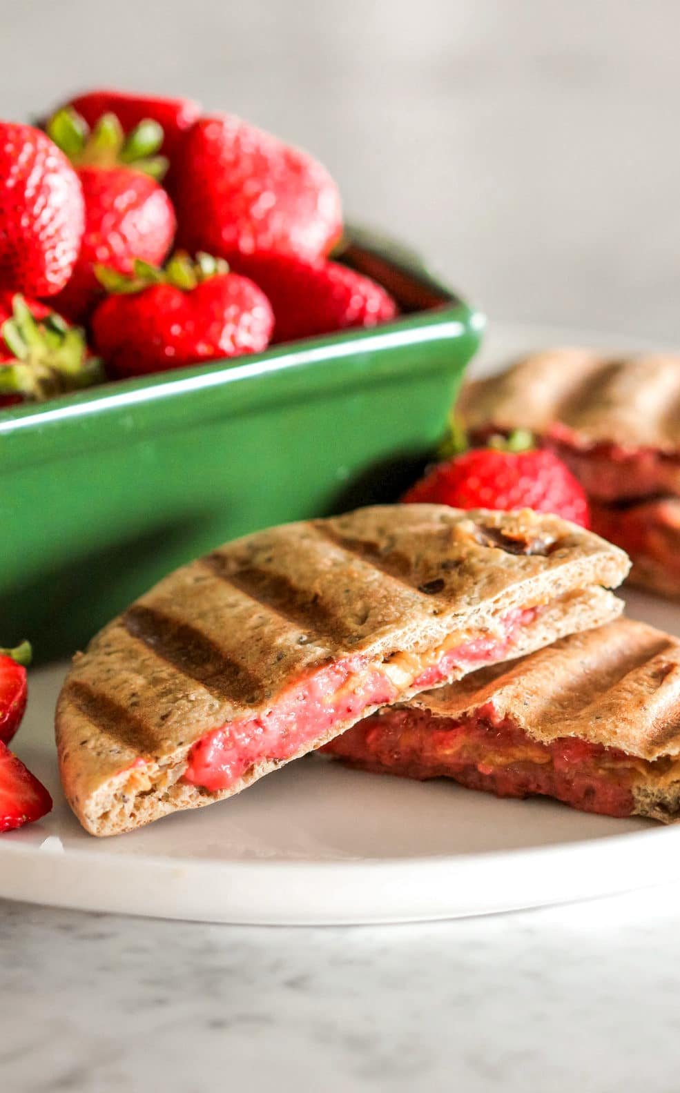 Step up your PB&J game with these 3-ingredient Healthy Peanut Butter & Jelly Paninis! Plus a recipe for Strawberry Chia Seed Spread. Your favorite childhood sandwich has been revamped to be not only healthier (vegan with no sugar added), but crisp on the outside, soft on the inside, providing comfort with every bite. Healthy Dessert Recipes with sugar free, low calorie, low fat, low carb, high protein, gluten free, dairy free, vegan, and raw options at the Desserts With Benefits Blog (www.DessertsWithBenefits.com)