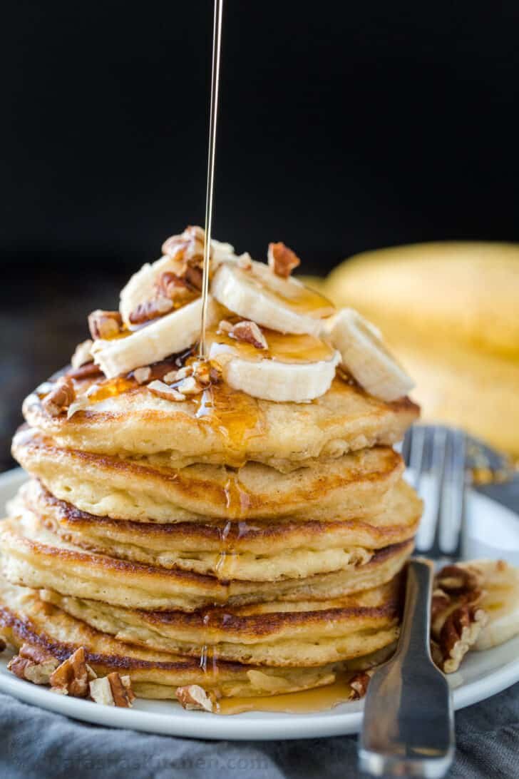 Stack of banana pancakes drizzled with maple syrup