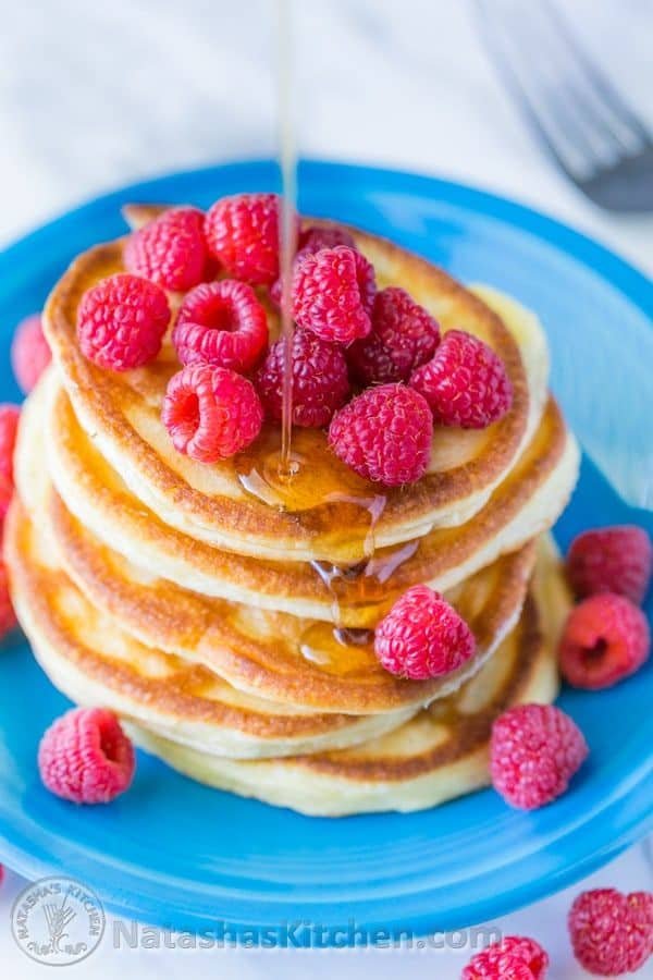 These Greek yogurt pancakes aren't your standard pancakes! They are delicate and crisp on the edges - delicious!| natashaskitchen.com