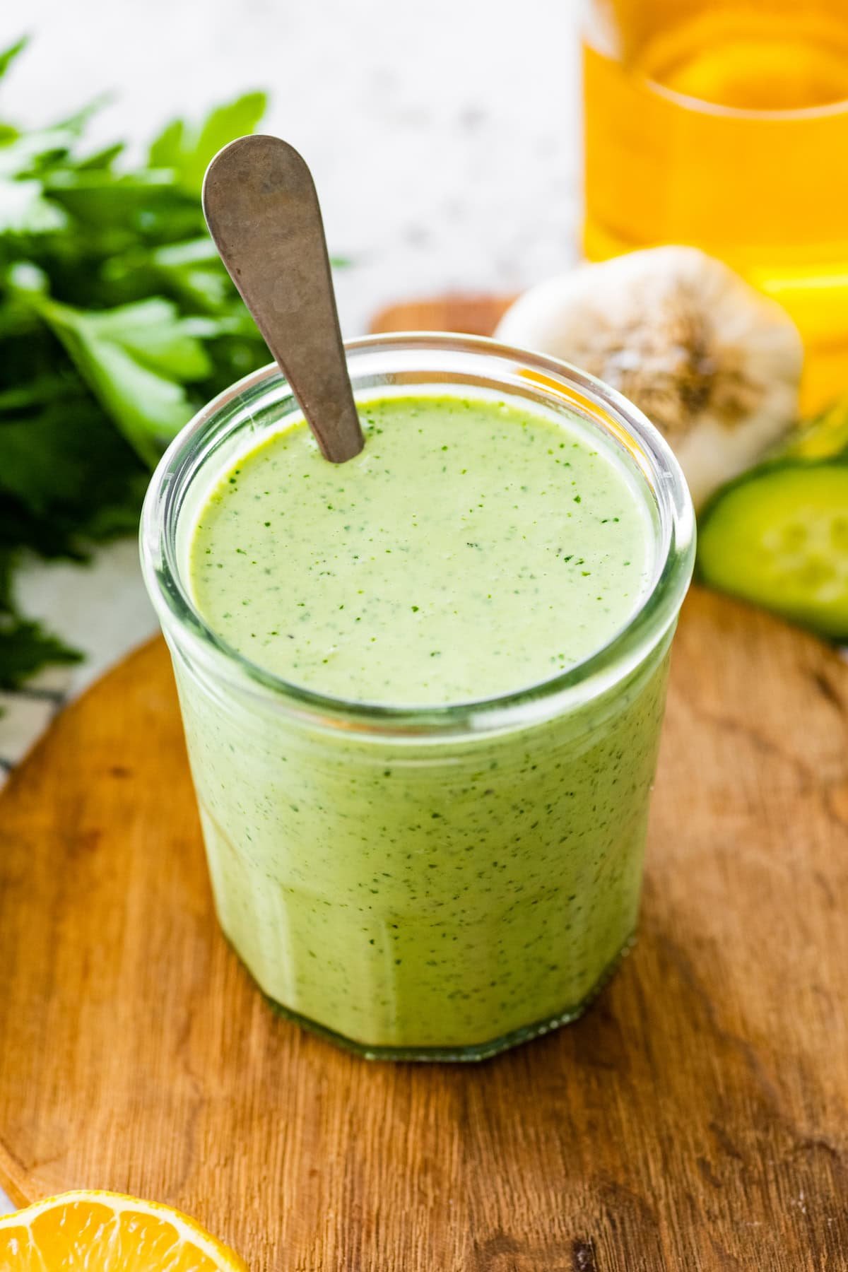 green goddess dressing in jar with spoon.
