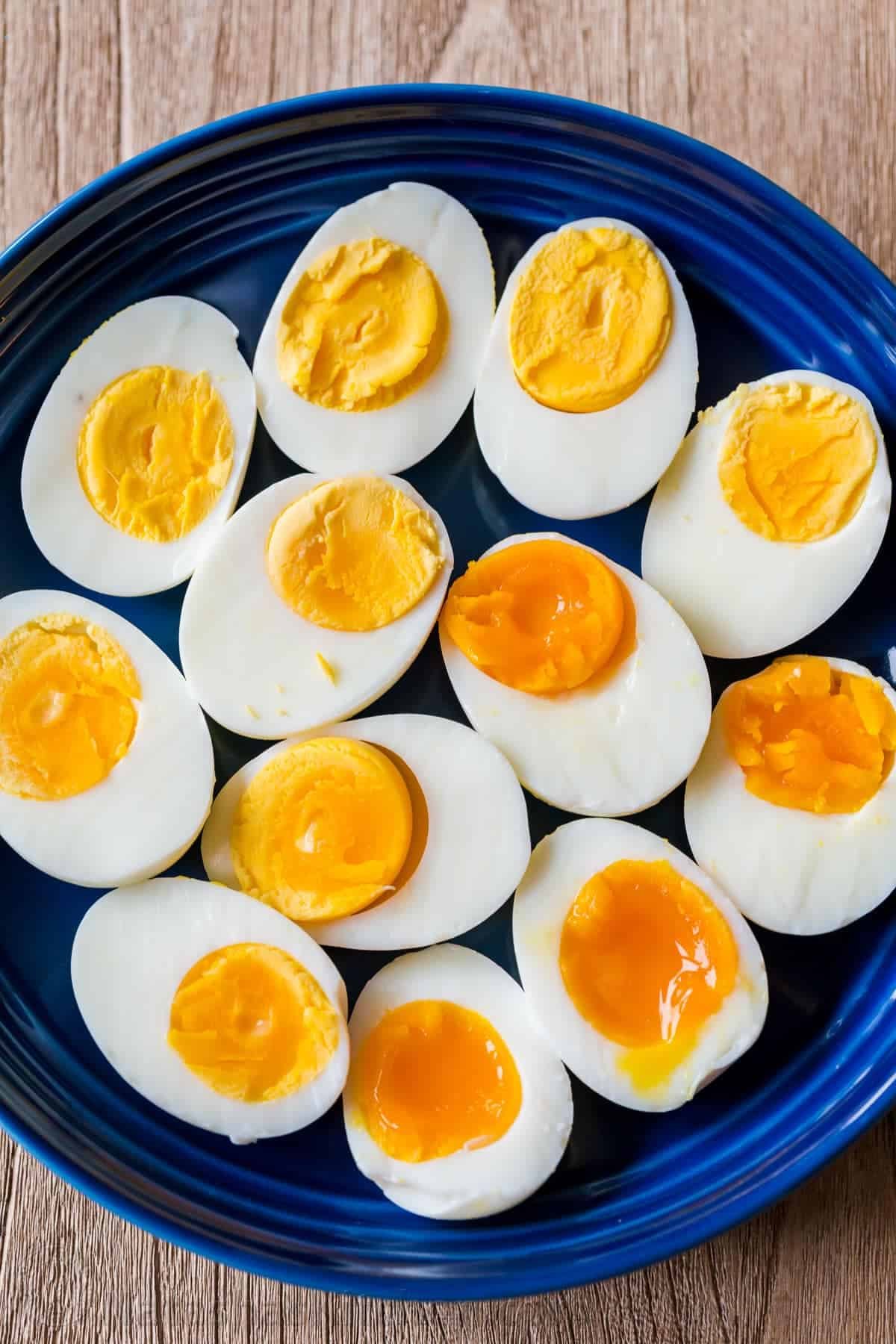 A tried and true method to make hard-boiled eggs. You'll love the easy time chart for perfect hard-boiled eggs or soft-boiled eggs every time. boiled eggs on a platter with hard boiled eggs, medium boiled eggs and soft boiled eggs