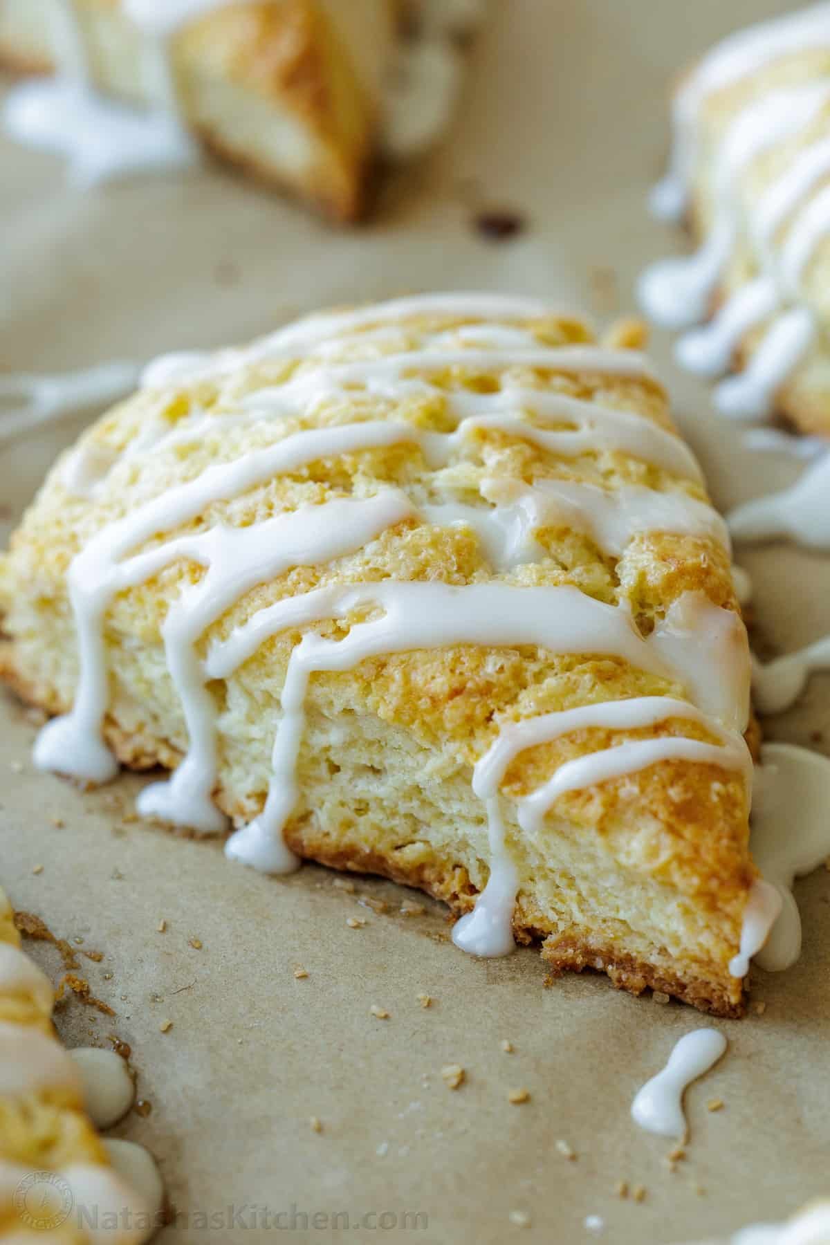 This classic Scone recipe is the perfect base for any homemade scones. Create delicious variations that will rival your favorite coffee shop scones. Classic baked scone drizzled with vanilla glaze, cut into wedges