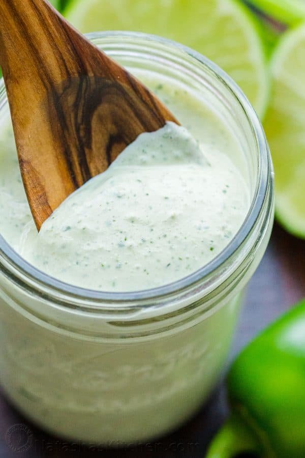 Close up jalapeno ranch recipe in mason jar with spoon in jar