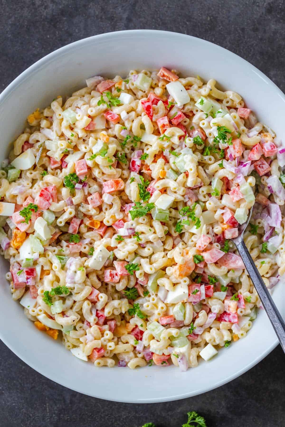 Macaroni Salad is perfect for a summer menu. Paired with BBQ meats, hot dogs, and hamburgers, it's the perfect creamy, refreshing side dish. Macaroni salad mixed with creamy dressing