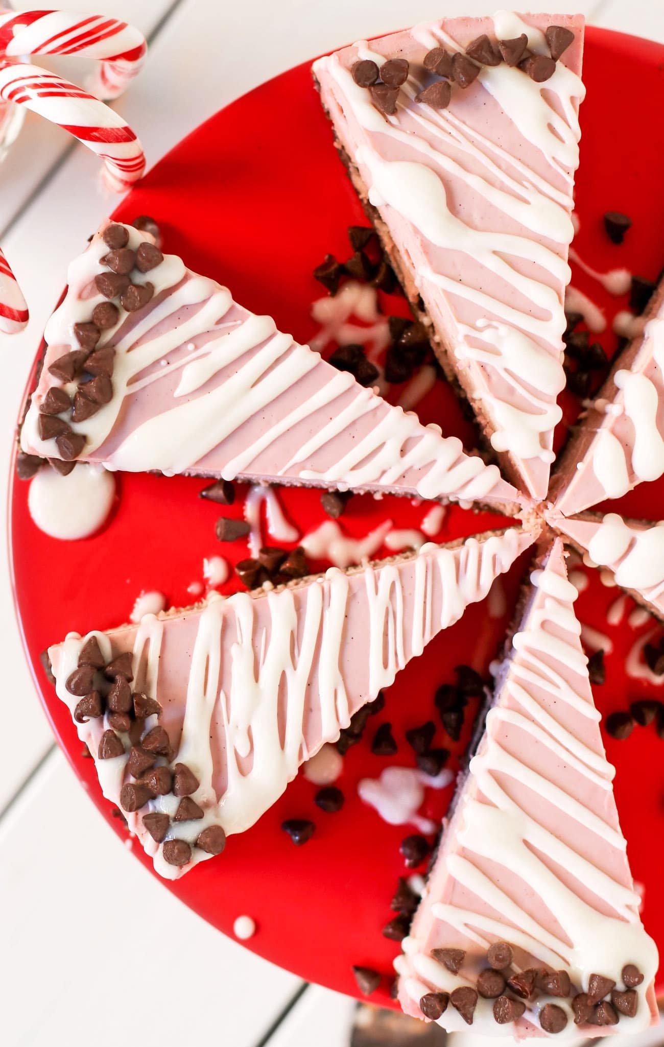 This deliciously rich and creamy no-bake Raw Vegan Peppermint Cheesecake is creamy without the cream cheese, fluffy without the eggs, and secretly sugar free and gluten free too!  No baking required, no water bath needed. Perfect for the holidays, birthdays, parties, or no reason at all!