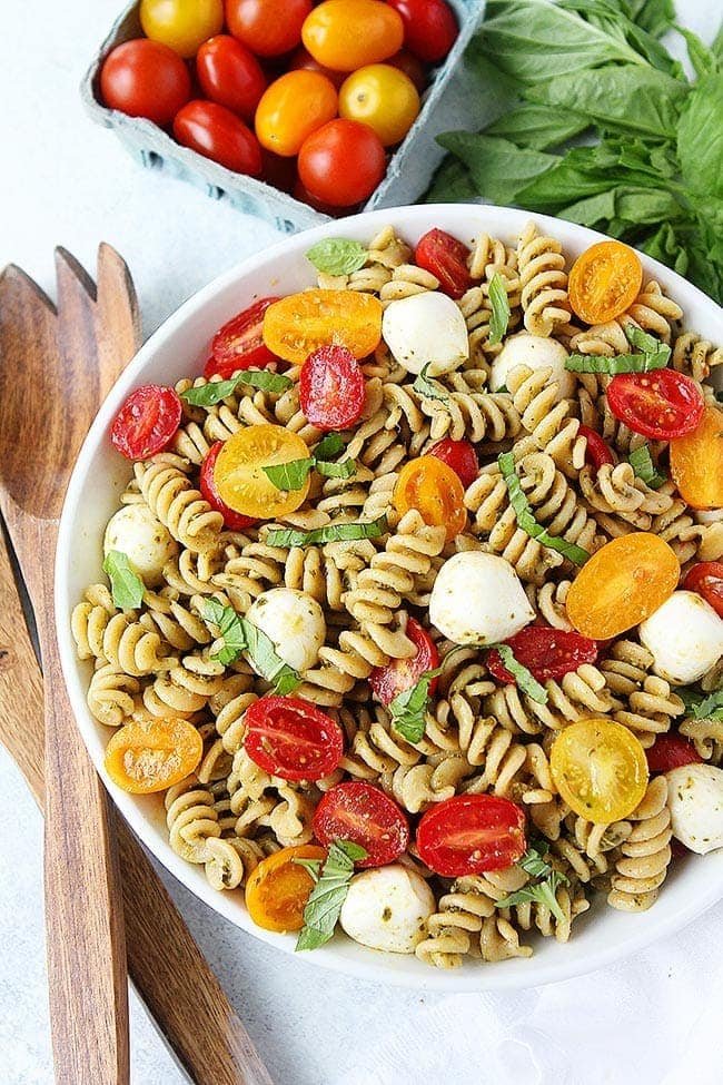 You only need 5 ingredients to make this easy Pesto Pasta Salad! It is the perfect pasta salad for summertime! #pesto #pasta #pastasalad #salad #vegetarian #basil #tomatoes #summer #easyrecipe Pesto Pasta Salad in bowl