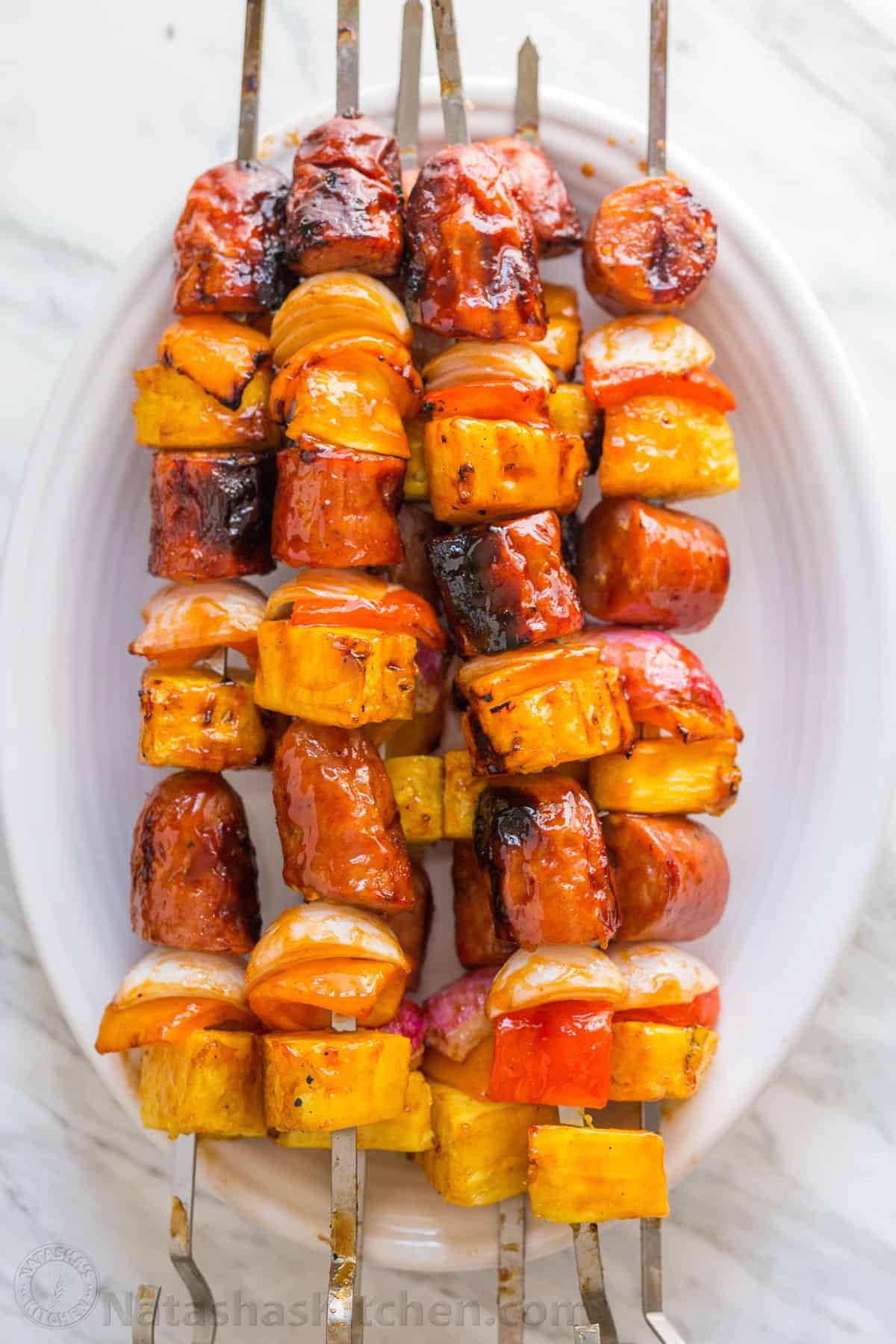 Grilled pineapple sausage Kabobs are sweet, spicy, smoky, and tasty! You'll love the easy glaze on these pineapple sausage kabobs. Grilled pineapple sausage skewers that are sweet, spicy, smoky and so flavorful! You won’t believe the easy glaze. Easy, excellent brunch skewers recipe. | natashaskitchen.com