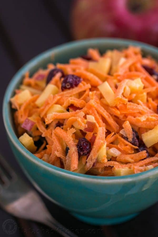 A close up of a bowl of carrot and apple salad