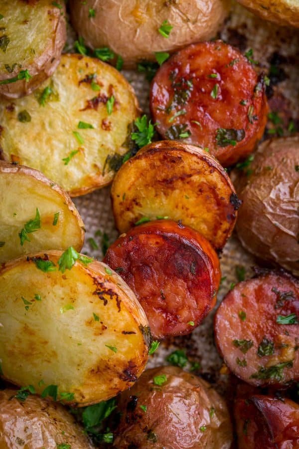 These roasted potatoes are ultra crispy and flavorful with a perfect browning on the coins of kielbasa. Easy, one-pan roasted potatoes and sausage recipe | natashaskitchen.com