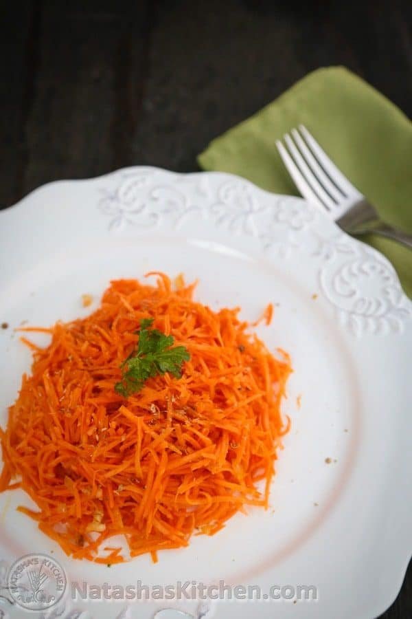 A white plate with carrot salad with coriander 