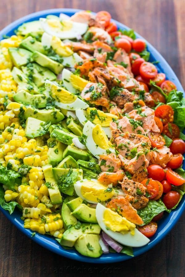 Salmon Cobb Salad served over a bed of lettuce with a zesty cilantro lime dressing