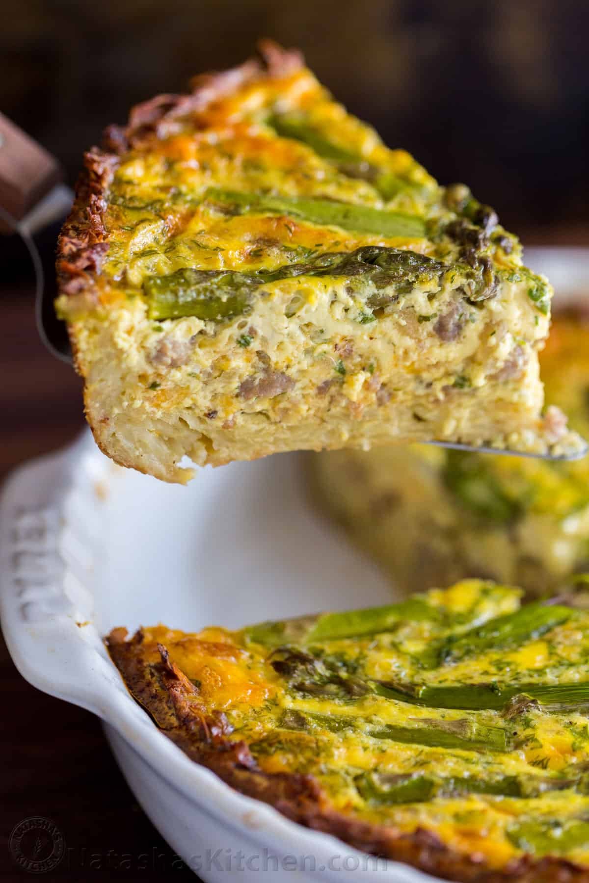 Every bite of this Sausage Asparagus Quiche is pure comfort. This classic quiche recipe is loaded with juicy sausage, eggs, fresh asparagus and herbs. | natashaskitchen.com