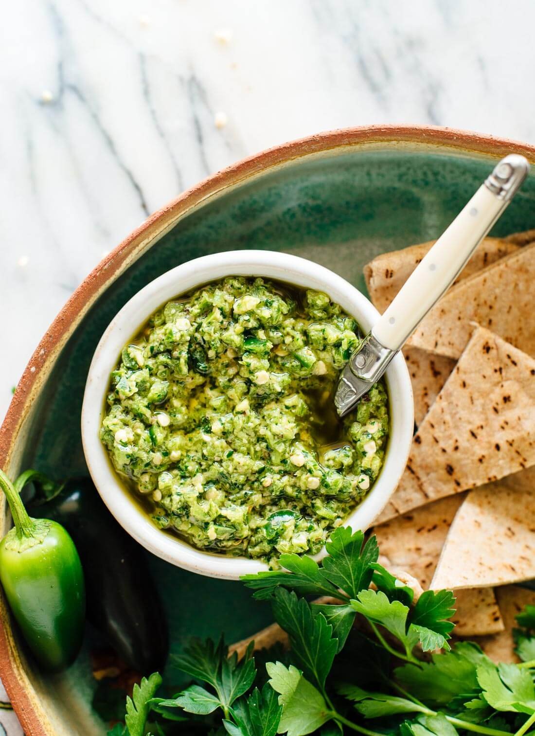 This shatta recipe is so good! It's a Middle Eastern hot sauce full of jalapeños and herbs. Add a spoonful of shatta to spice up your meals!