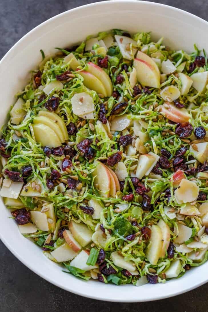 Shaved Brussels sprouts salad in white bowl