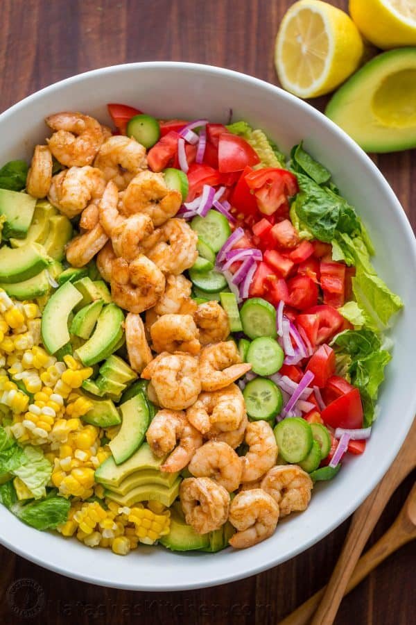 Shrimp Cobb Salad with a chopped romaine base layered with cajun shrimp, avocado, and tomatoes