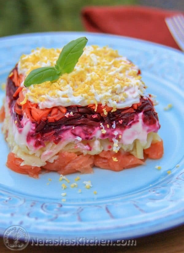 A piece of shuba with salmon on a white plate 