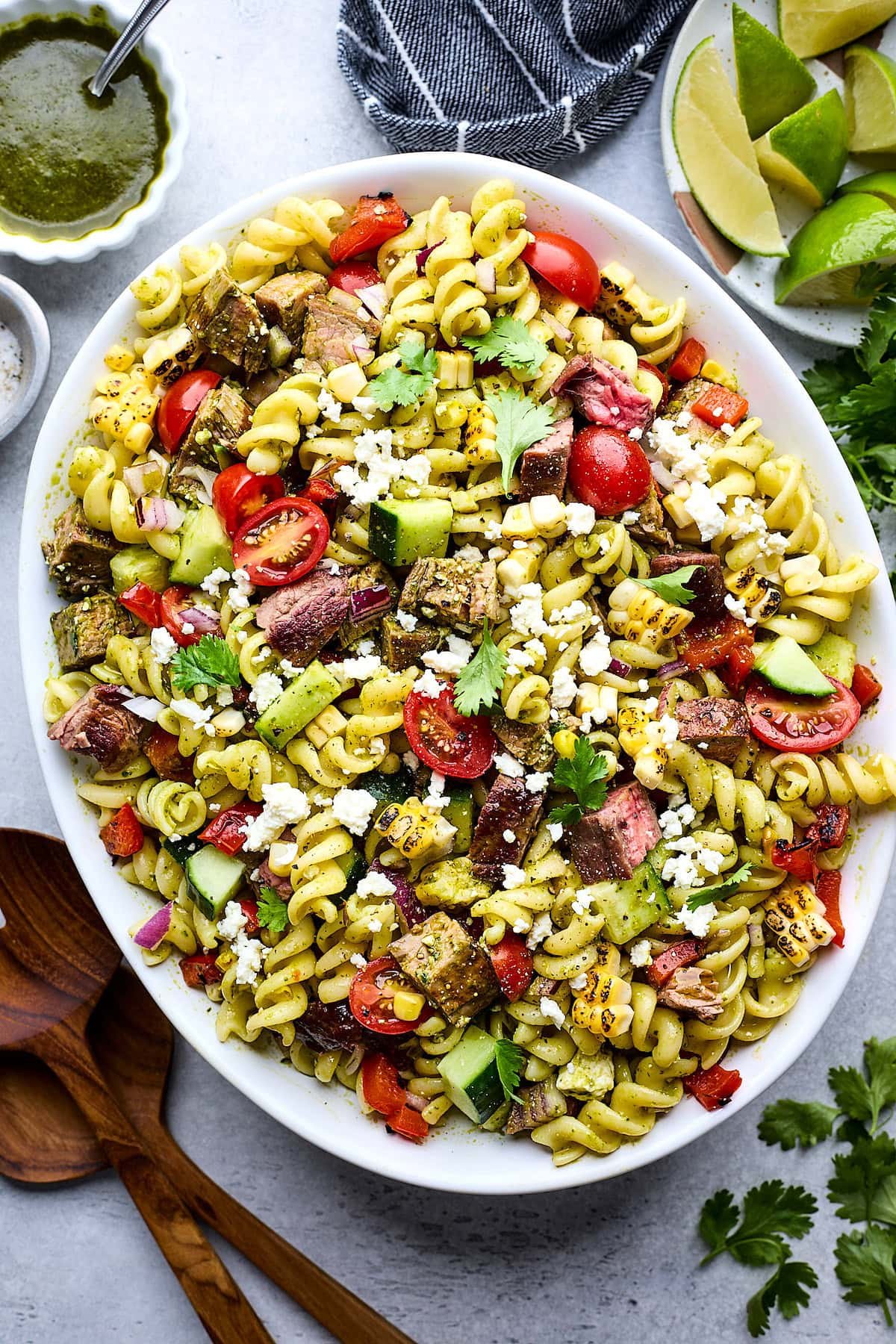 steak pasta salad in white serving bowl.