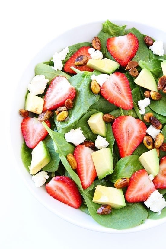 Strawberry Spinach Salad with Avocado, Goat Cheese, and Candied Pistachios Recipe on twopeasandtheirpod.com A great salad for spring and summer! Strawberry Spinach Salad with Avocado, Goat Cheese, and Candied Pistachios Recipe