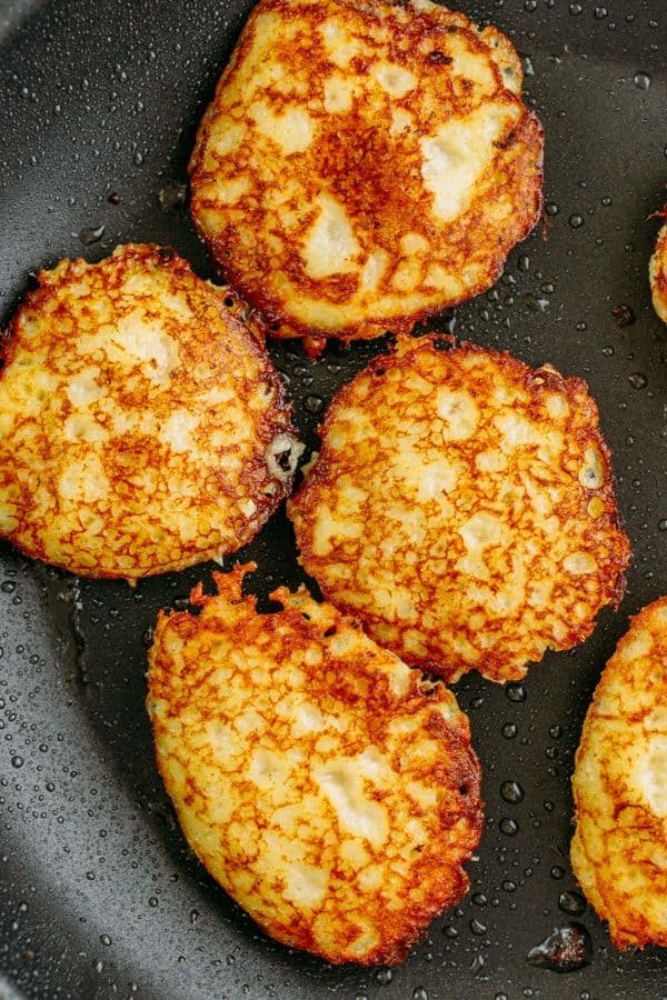 Draniki (aka deruny), are Russian stuffed potato pancakes made with grated potatoes. These are stuffed with a juicy meat patty - a delicious surprise! | natashaskitchen.com