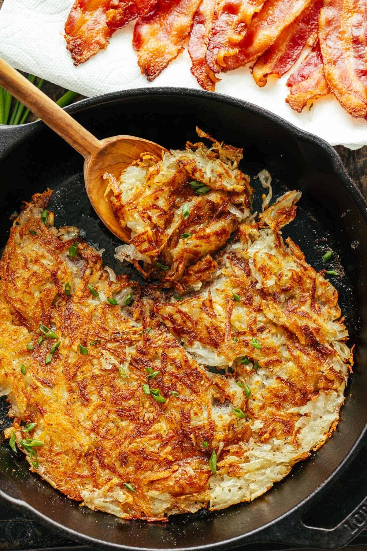 Here’s the secret to making the best Crispy Hash Browns - the perfect breakfast side dish. A classic homemade Hash Brown Recipe. Hash browns in a cast iron skillet with a serving spoon
