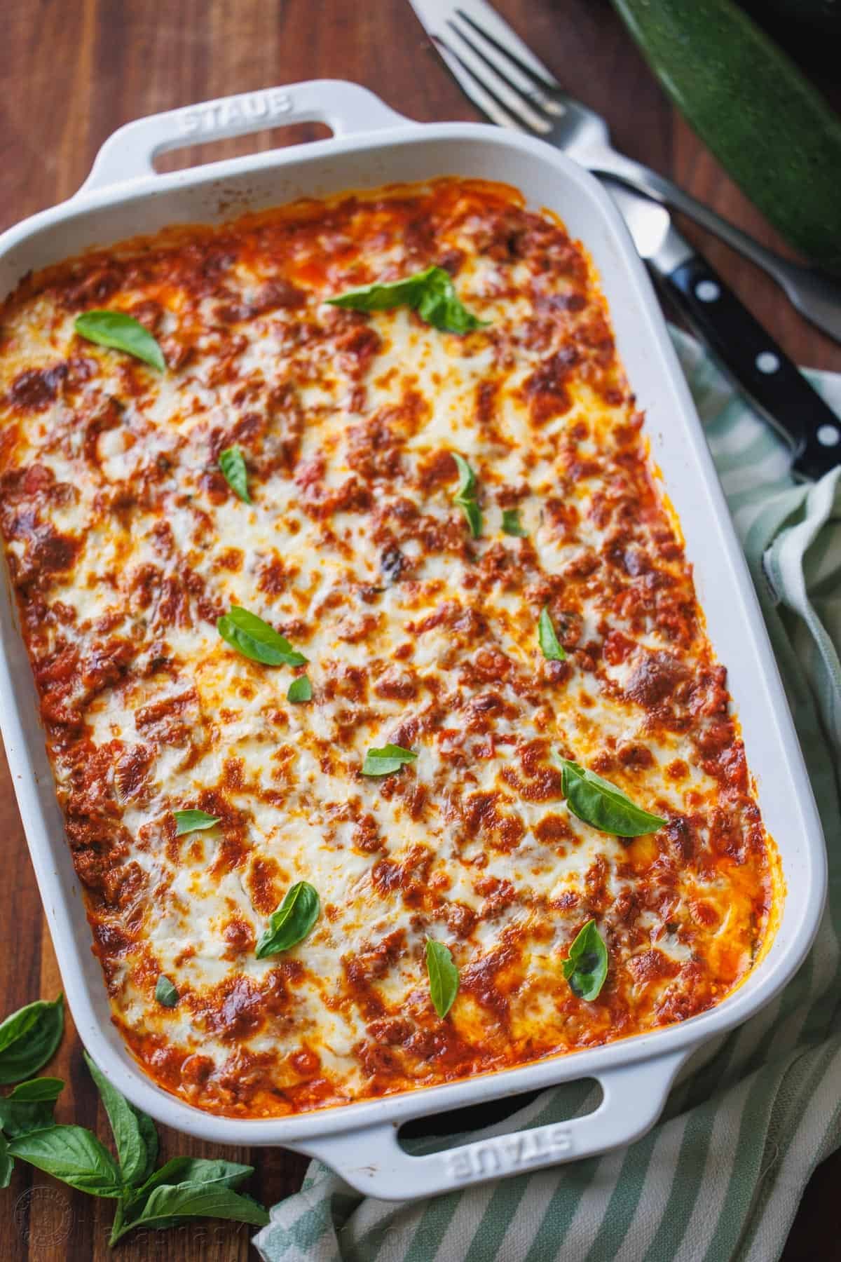 Zucchini lasagna tastes just like the cheesy traditional Italian recipe but with fewer calories and more nutrients. You won't miss the pasta! Traditional Italian dish made with layers of cheese and meat sauce and without pasta ribbons