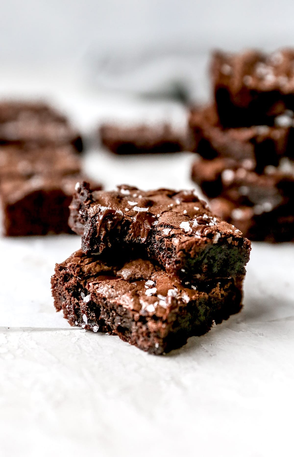 gluten free brownies stacked with flaky sea salt.