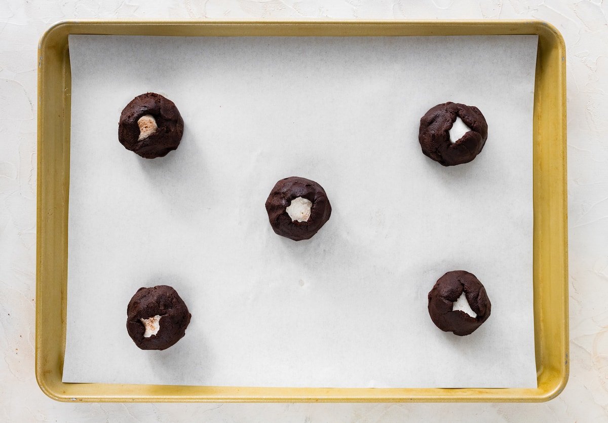 peppermint mocha marshmallow cookie dough balls on baking sheet with parchment paper.