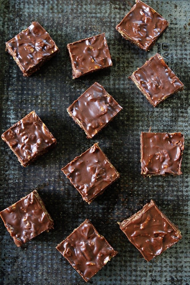 Crunchy No-Bake Chocolate Peanut Butter Bars Recipe on twopeasandtheirpod.com These bars are SO easy to make at home and are better than any store bought candy bar! Crunchy No-Bake Chocolate Peanut Butter Bars Recipe