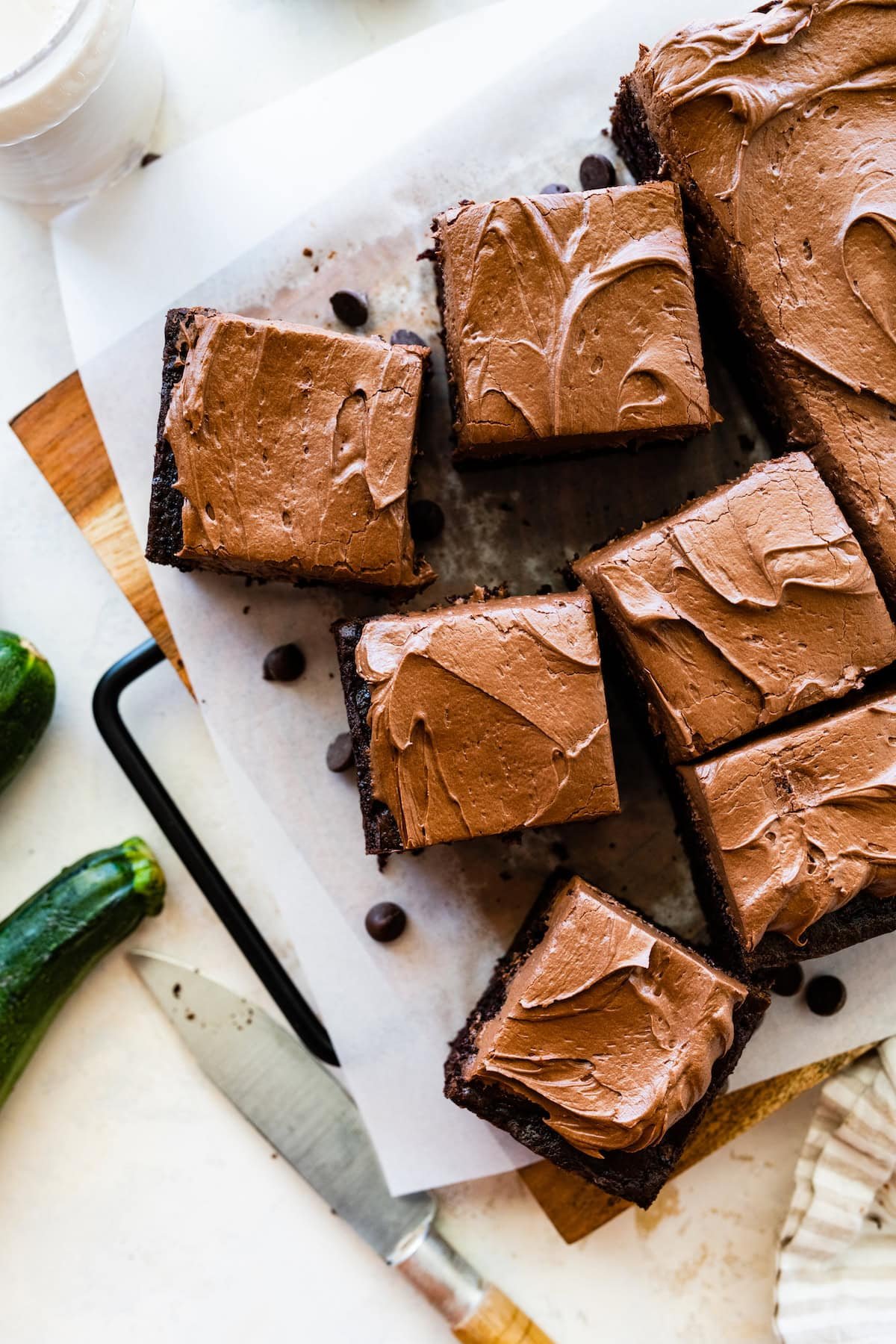 chocolate zucchini cake with chocolate frosting cut into squares. 