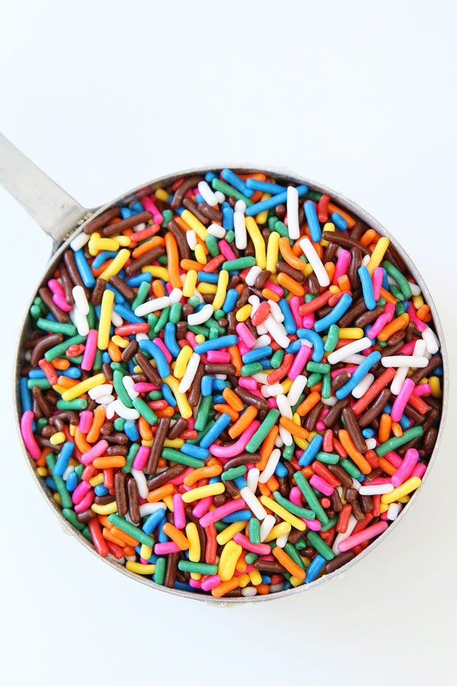 Sprinkle Chocolate Chip Cookies Recipe on twopeasandtheirpod.com Chocolate chip cookies covered in bright colored sprinkles. These cookies are perfect for any celebration! Rainbow Sprinkles
