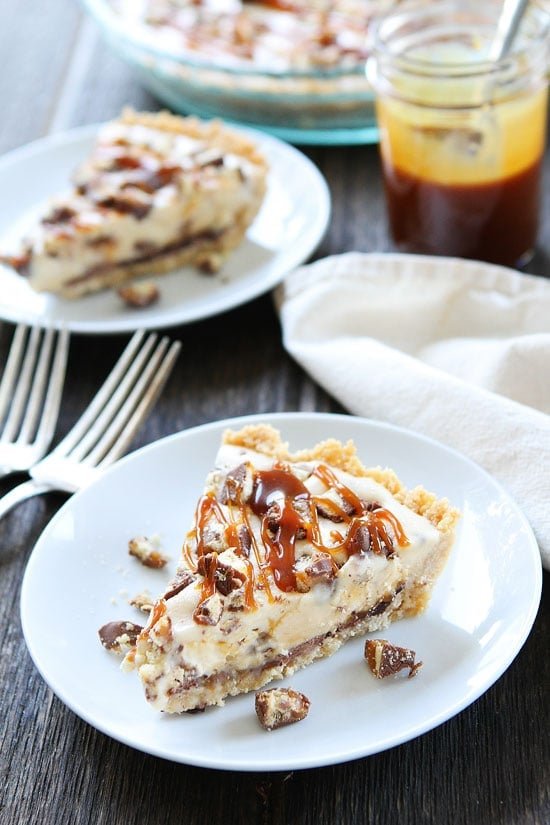 Twix Ice Cream Pie Recipe on twopeasandtheirpod.com Shortbread cookie crust with a layer of chocolate, vanilla ice cream, chopped Twix candy bars, and salted caramel sauce. The BEST summer dessert! Twix Ice Cream Pie with shortbread crust