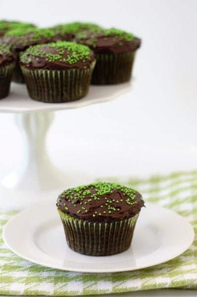 chocolate-zucchini-cupcakes2 chocolate zucchini cupcake on plate with green sprinkles.
